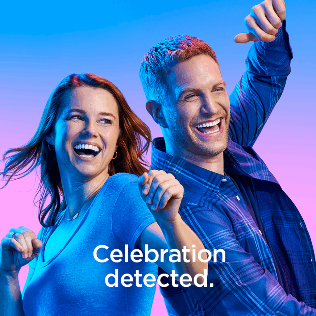 Two joyful people celebrating, with text 'Celebration detected,' promoting SureSmile Clear Aligners at Renewal Family Dental in Dearborn.