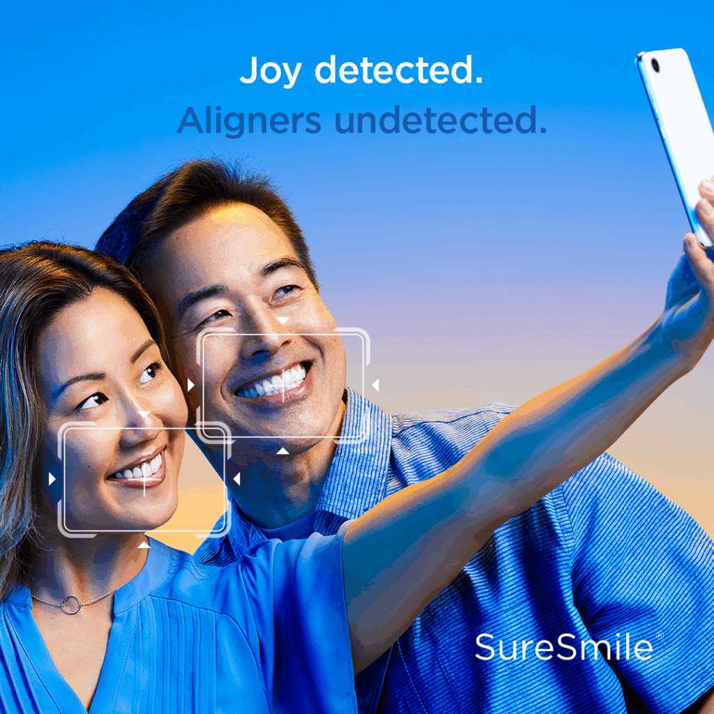 A smiling couple taking a selfie, with text 'Aligners undetected,' promoting SureSmile Clear Aligners at Renewal Family Dental in Dearborn.