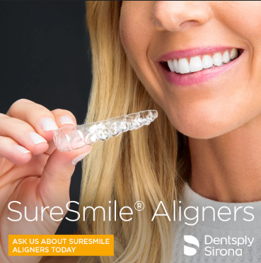 A smiling woman holding SureSmile Clear Aligners, highlighting their availability in Dearborn at Renewal Family Dental.